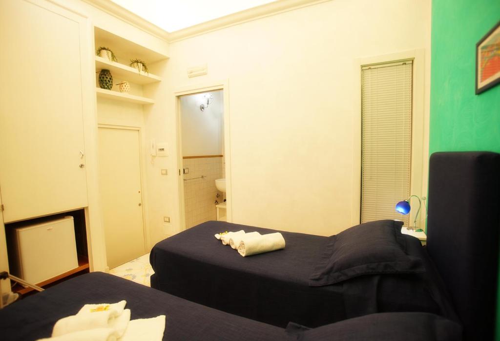A bed or beds in a room at Le Vie Di Napoli B&B