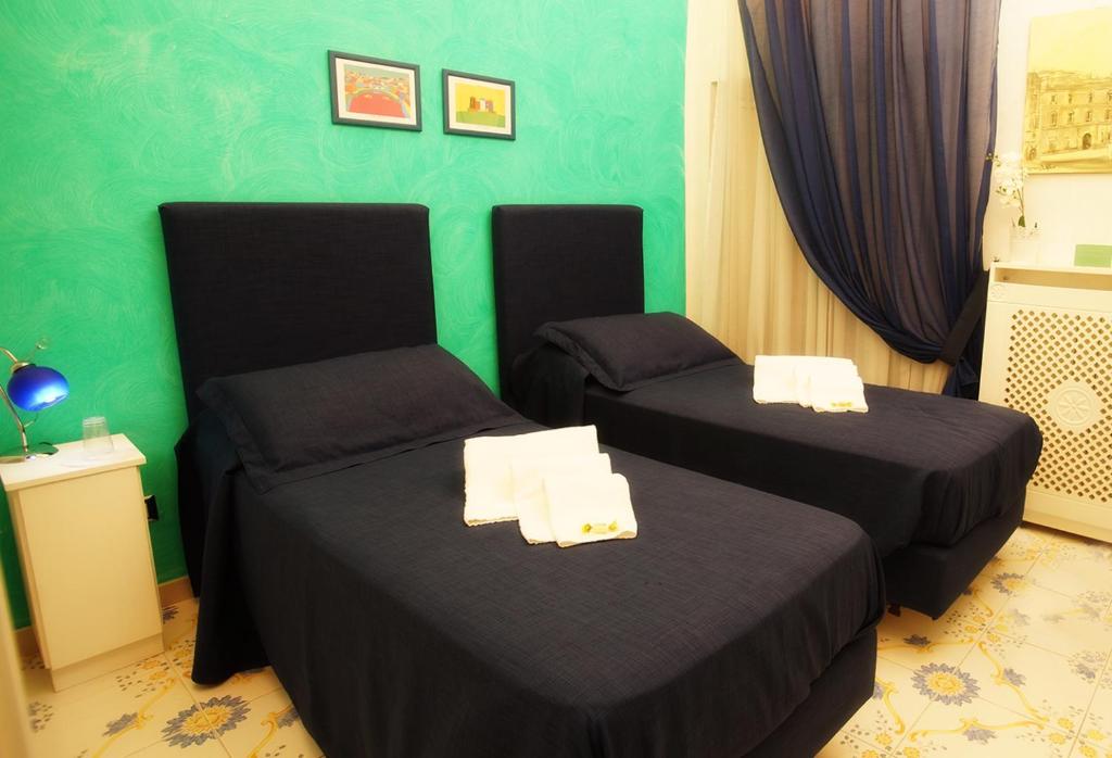 A bed or beds in a room at Le Vie Di Napoli B&B