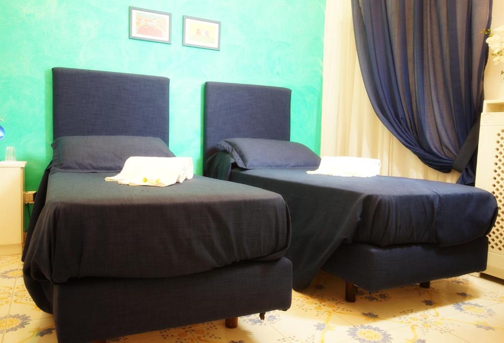 A bed or beds in a room at Le Vie Di Napoli B&B