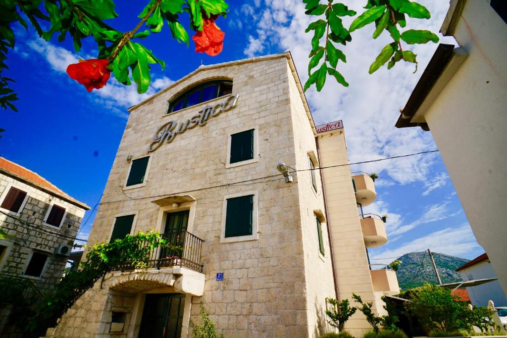 un bâtiment avec un panneau sur son côté dans l'établissement Villa Rustica Dalmatia, à Seget Vranjica