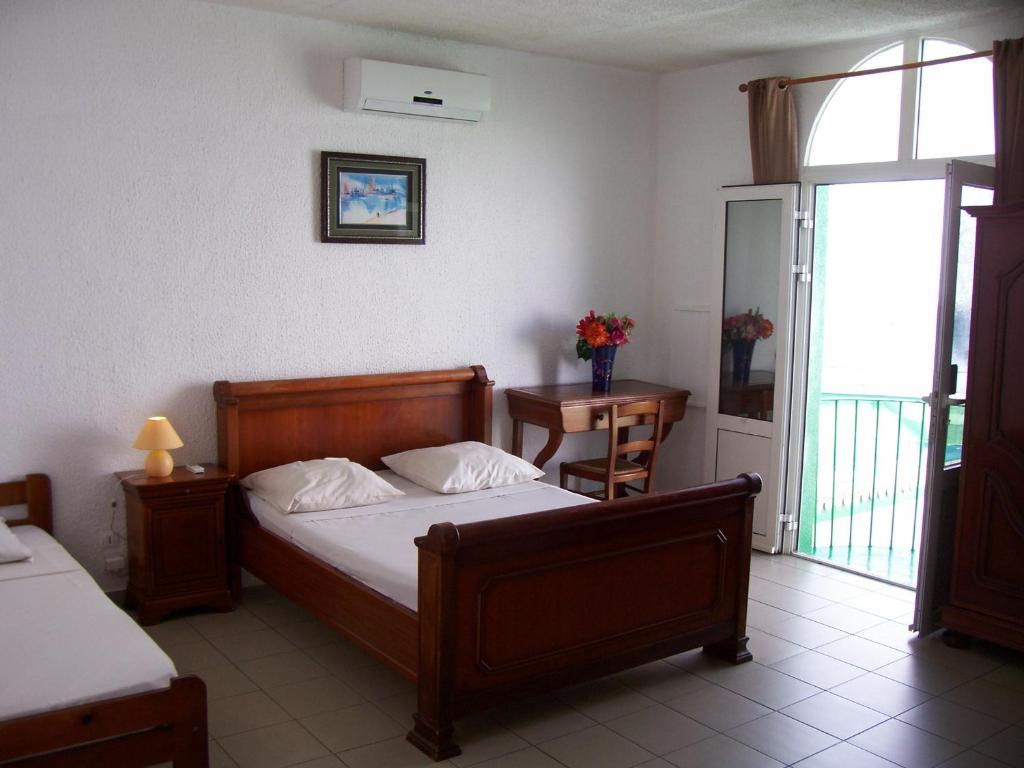Postel nebo postele na pokoji v ubytování Hôtel Le Nathania