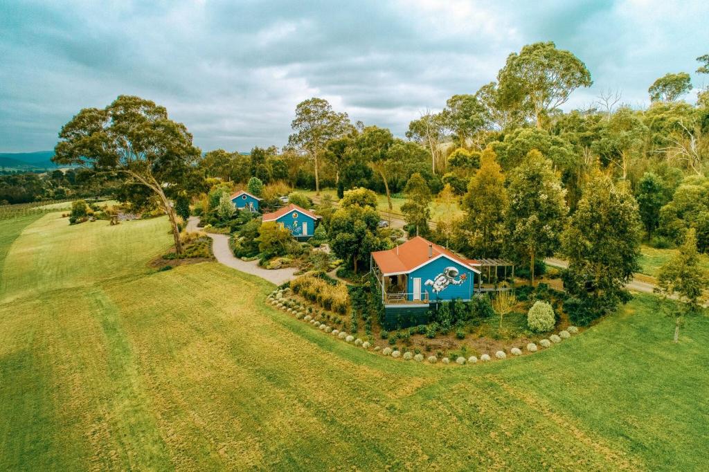 an aerial view of a house in a field at Outlook Hill Vineyard Cottages & Suites in Healesville