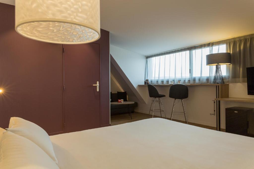 Postel nebo postele na pokoji v ubytování Hôtel Originals City, Armony Dijon - Chenôve