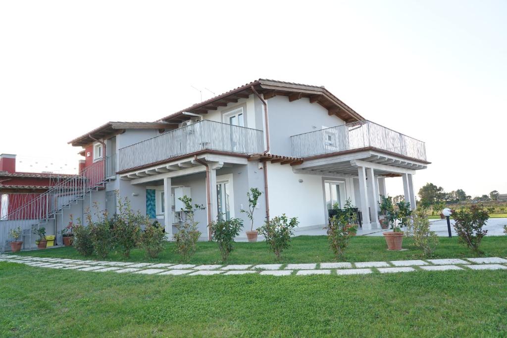 a house with a balcony on top of it at Imperial casa vacanze in Ladispoli