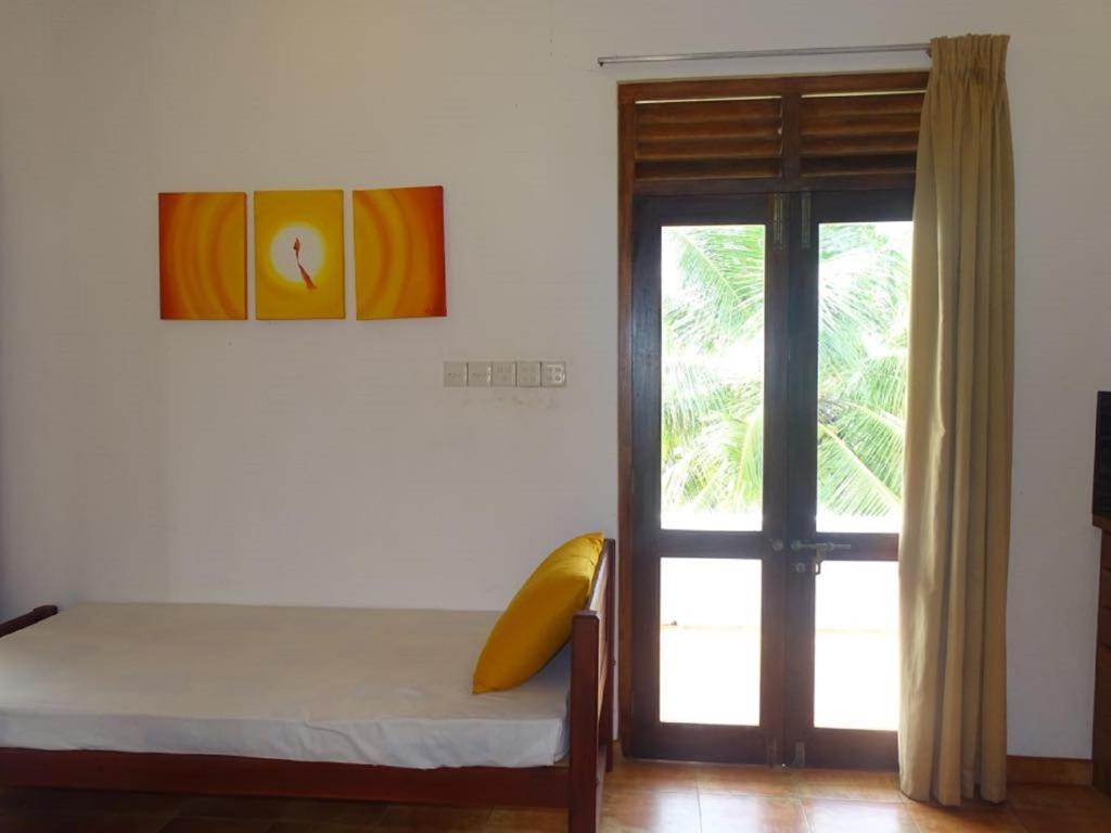 Postel nebo postele na pokoji v ubytování Jasmine Garden Beach Guest House