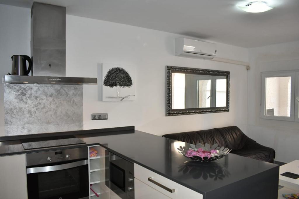 a kitchen with a black counter top and a stove at La Mata Apartments in Torrevieja