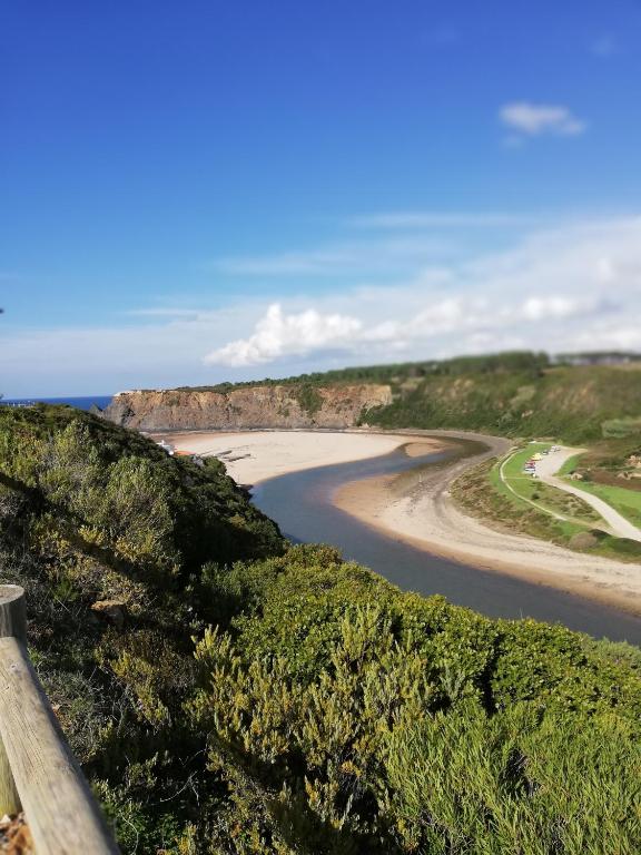 a view of a beach from a hill at Sol Mar in Odeceixe