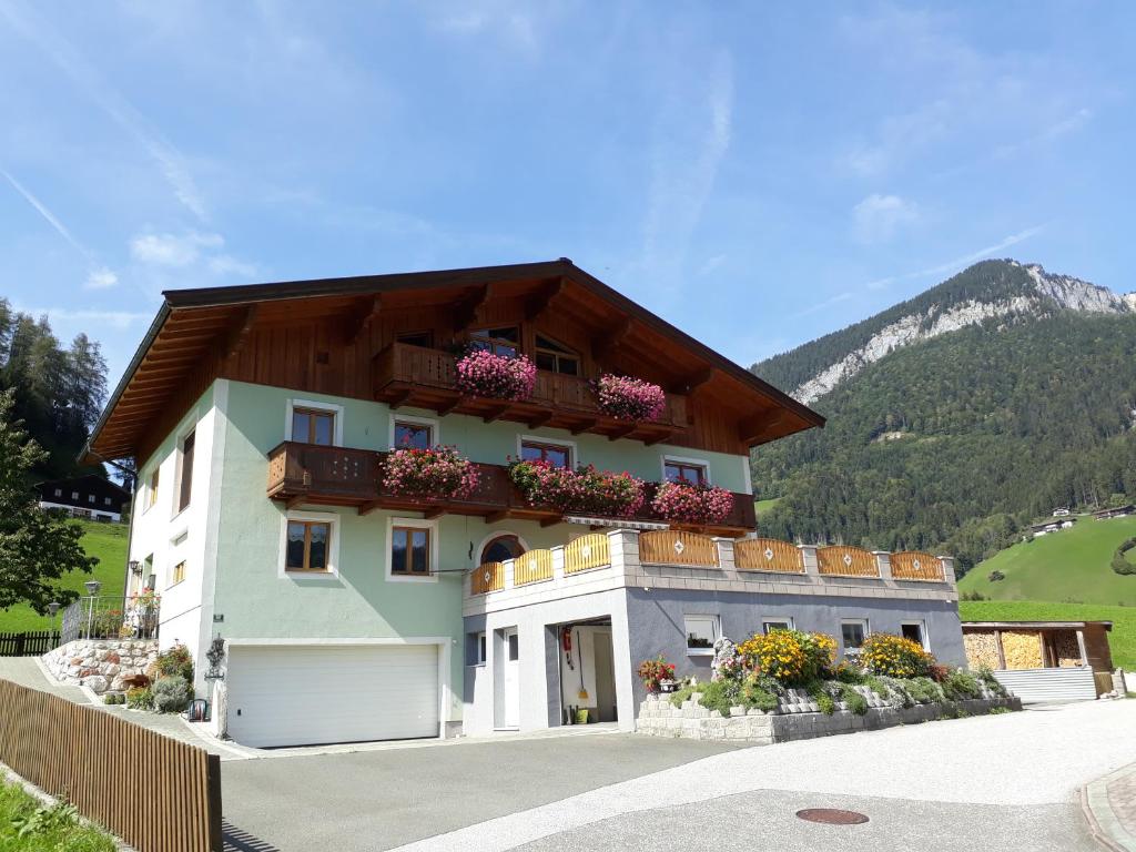 a building with flower boxes on the top of it at Haus Bergheim in Unken