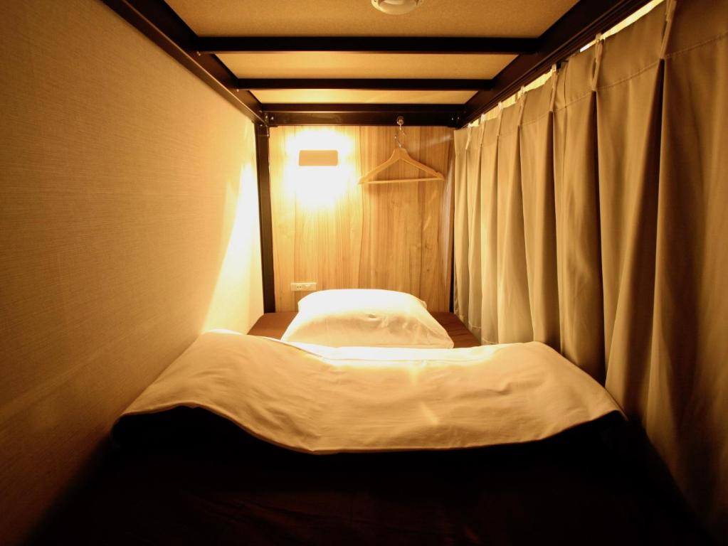 Postel nebo postele na pokoji v ubytování Namba Guesthouse HIVE