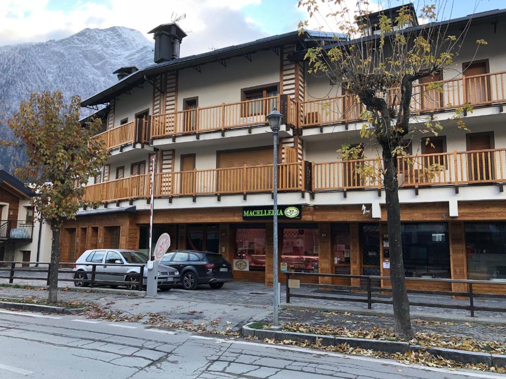a large building with cars parked in front of it at PETITE MAISON a 50 passi dalla funivia !!! in Courmayeur