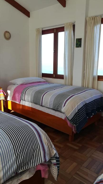 Postel nebo postele na pokoji v ubytování Hostal Inti Wayra