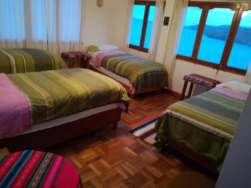 Postel nebo postele na pokoji v ubytování Hostal Inti Wayra