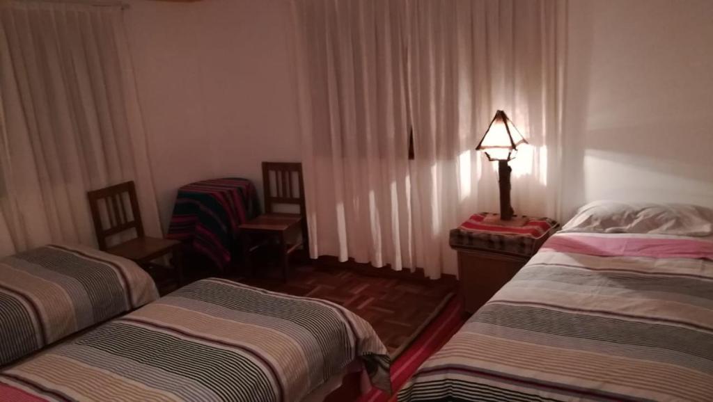 Postel nebo postele na pokoji v ubytování Hostal Inti Wayra