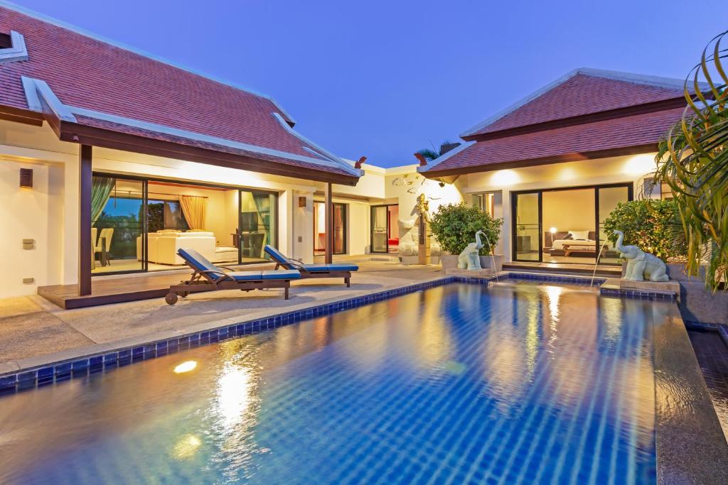 a swimming pool in front of a house at Villa Bianca in Rawai Beach