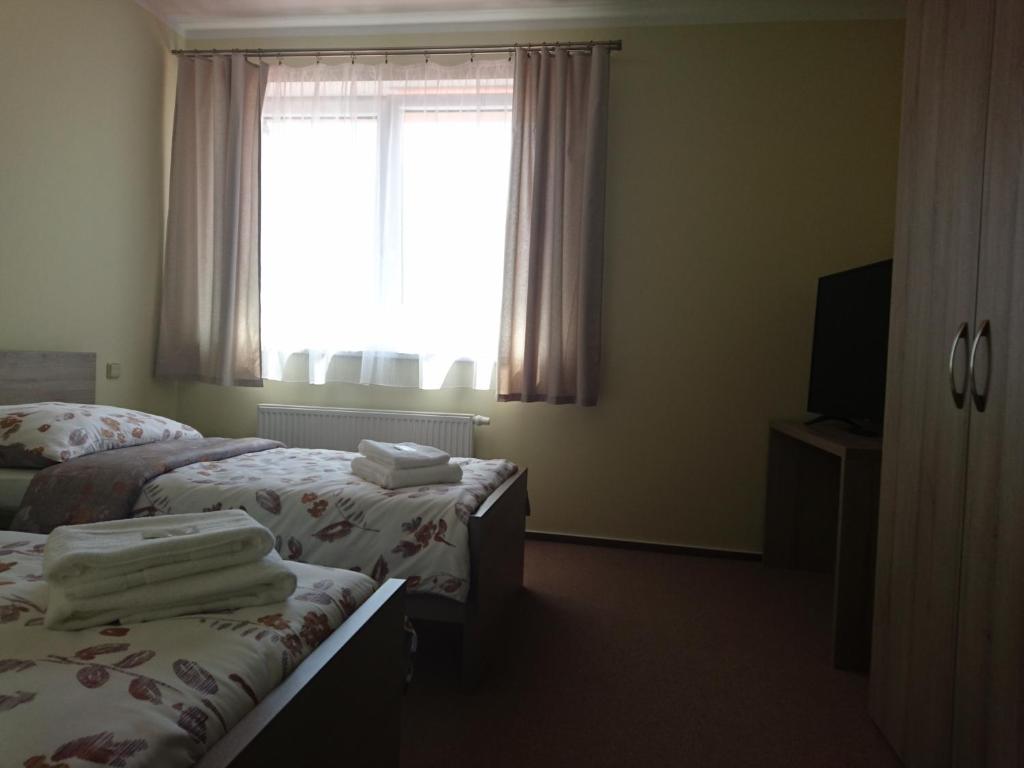 Postel nebo postele na pokoji v ubytování Penzion OSTROV