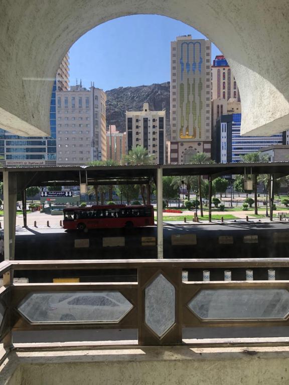 a view of a city from a bridge with a bus at Guest House Hotel Apartments Makkah in Makkah