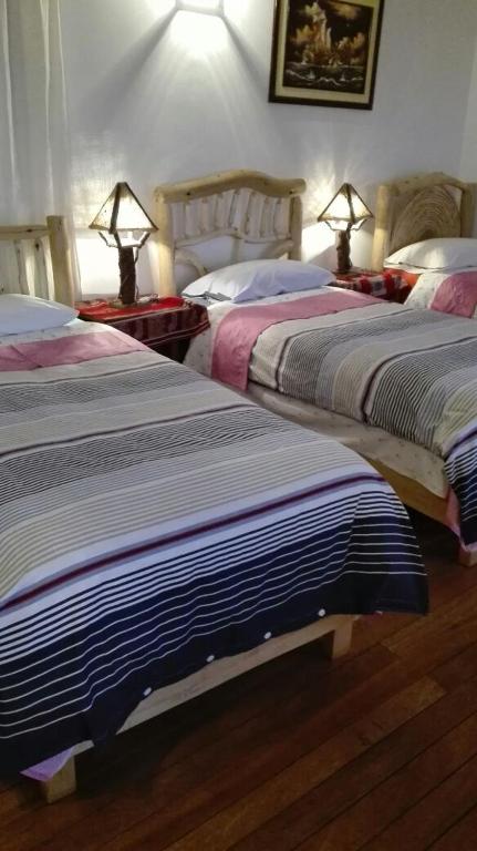 Postel nebo postele na pokoji v ubytování Hostal Inti Wayra