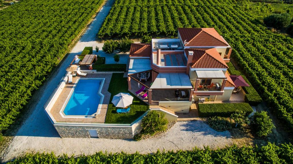 an aerial view of a house with a swimming pool at Cretan Vineyard Hill Villa in Káto Kalésia