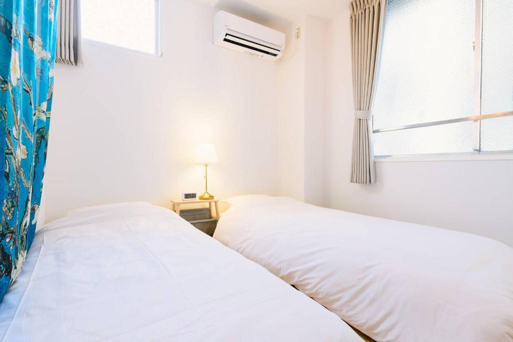 Postel nebo postele na pokoji v ubytování TEN APARTMENT HOTEL