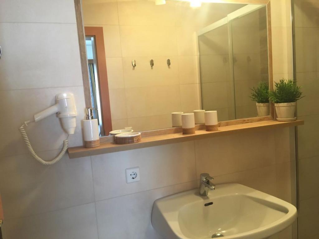 a bathroom with a sink and a mirror and a phone at Appartement Pichler in Radstadt