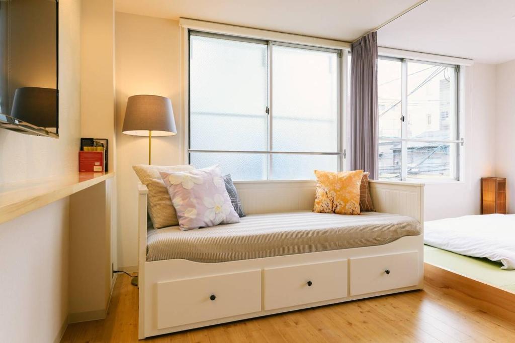 Postel nebo postele na pokoji v ubytování TEN APARTMENT HOTEL