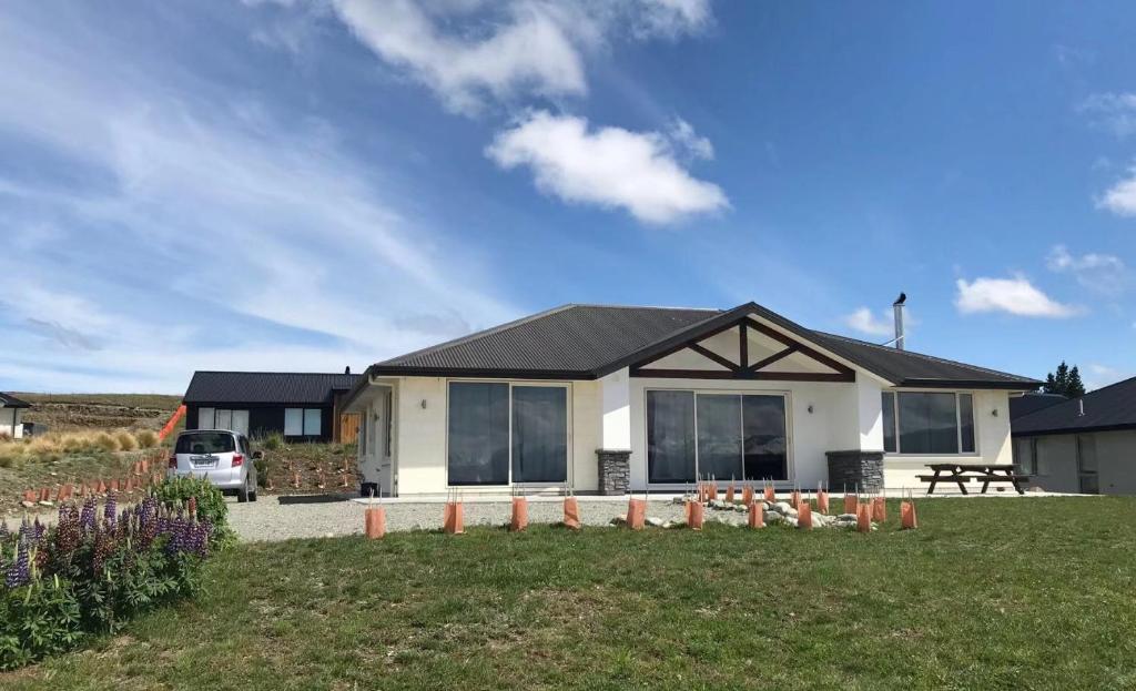 a house with a car parked in front of it at Tesoro in Lake Tekapo