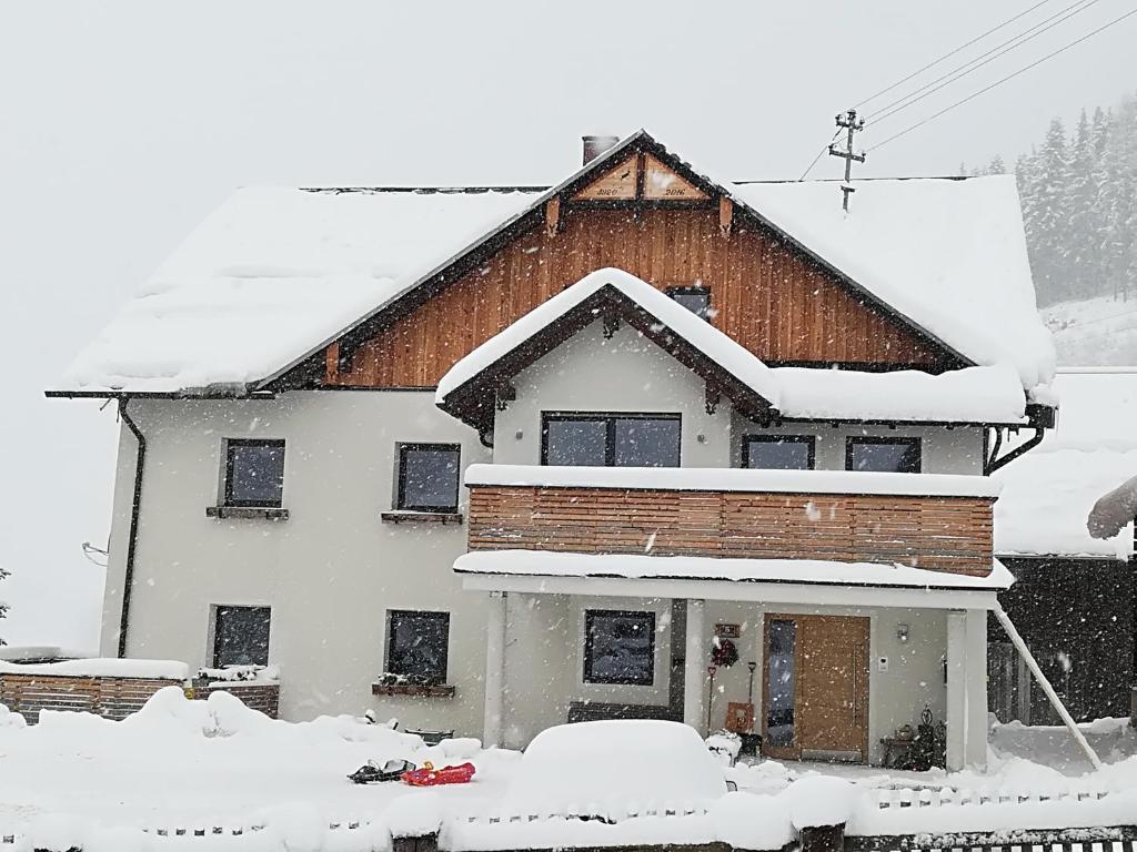 a house with snow on the roof of it at Appartement Großwallner in Radstadt