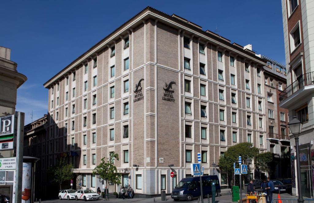 a large brick building on a city street at Hotel Liabeny in Madrid