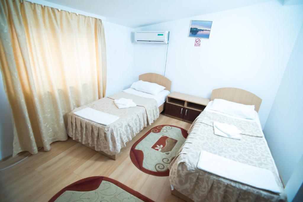 Letto o letti in una camera di Pensiunea Melisa