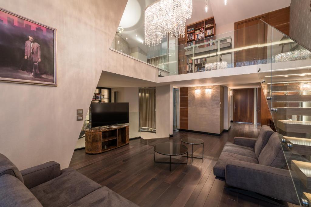 a living room with two couches and a tv at Castle Apartments Budapest in Budapest