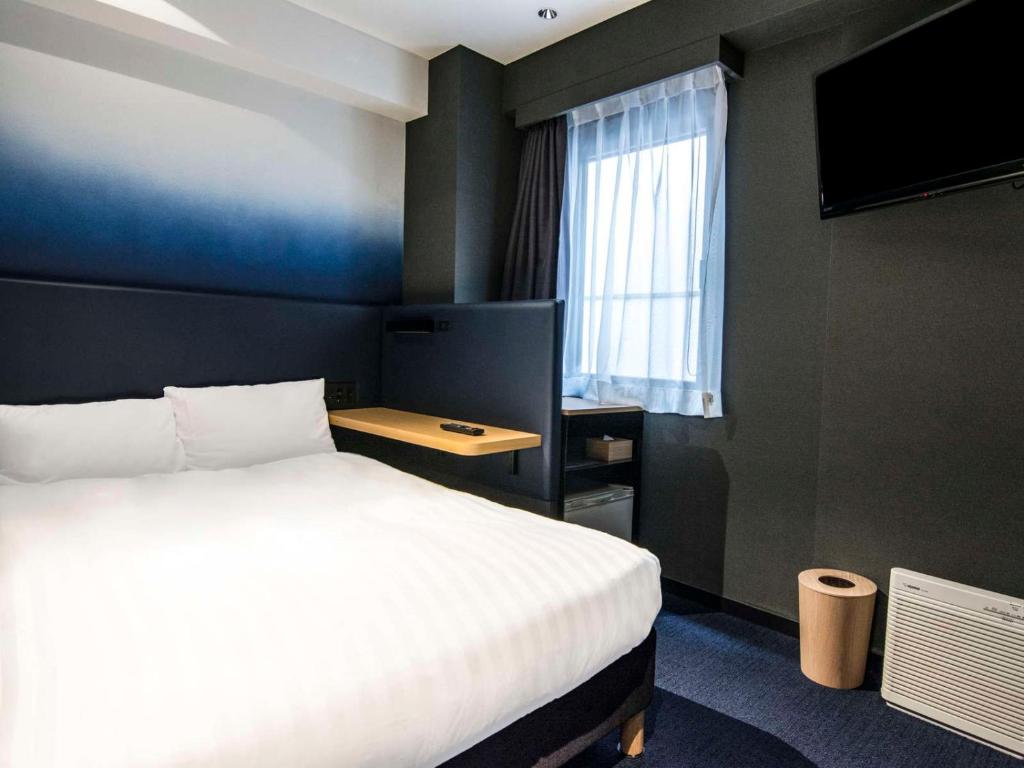 Postel nebo postele na pokoji v ubytování Hotel New Shohei