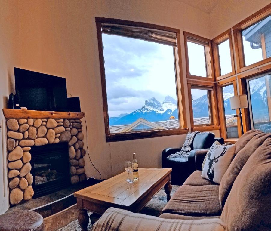 a living room with a couch and a fireplace at Downtown Loft, Mountain Views, Fireplace, Couple's Retreat, Walker's Paradise in Canmore
