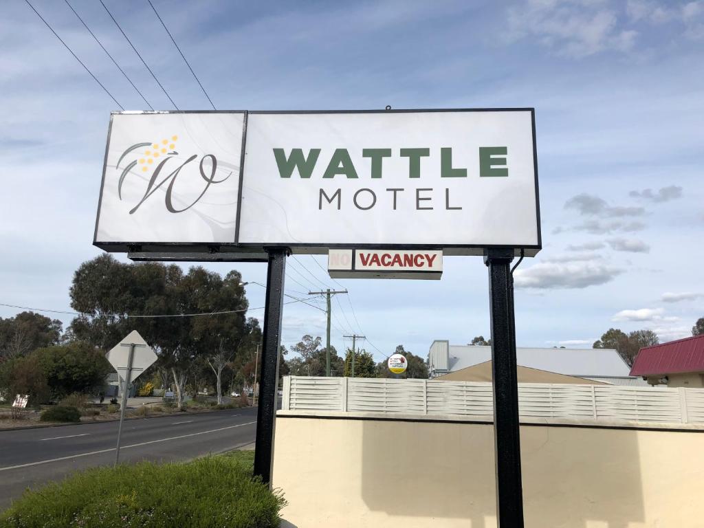 a sign for a waiting motel on the side of a road at Wattle Motel in Seymour