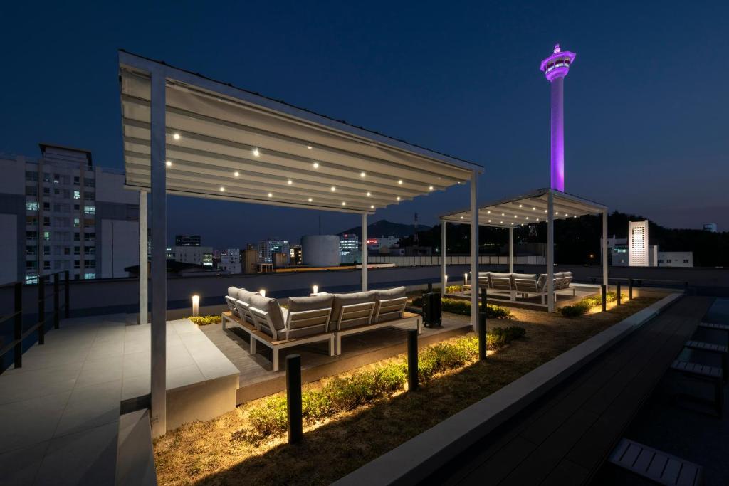 a view of a rooftop at night with a tower at No. 25 Signature Hotel Daecheong in Busan