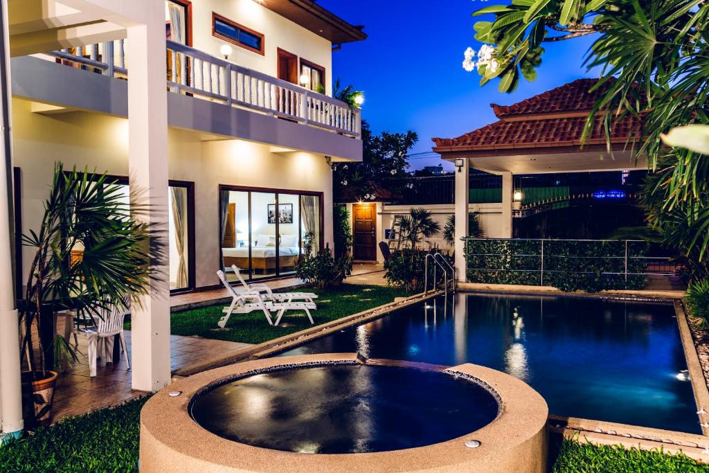 a house with a swimming pool in the yard at Avoca Pool Villas in Pattaya South