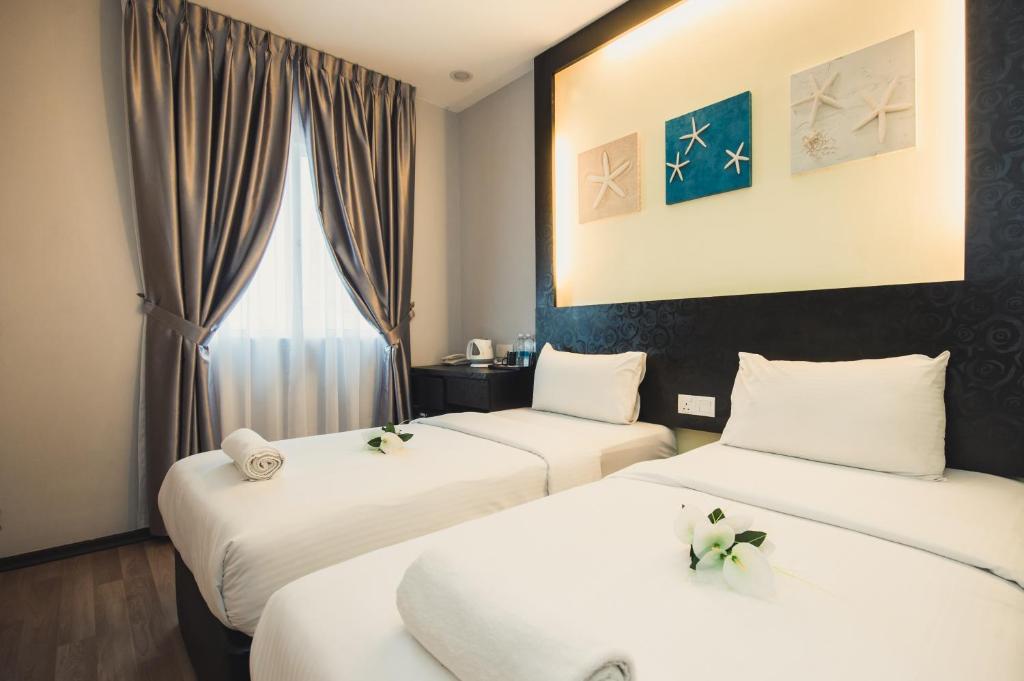 Postel nebo postele na pokoji v ubytování Hotel CIQ @ Wong Ah Fook