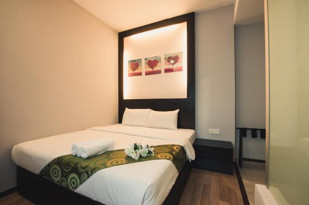 Postel nebo postele na pokoji v ubytování Hotel CIQ @ Wong Ah Fook