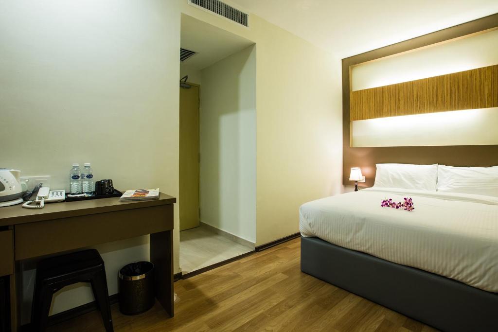 Postel nebo postele na pokoji v ubytování Hotel CIQ @ Wong Ah Fook