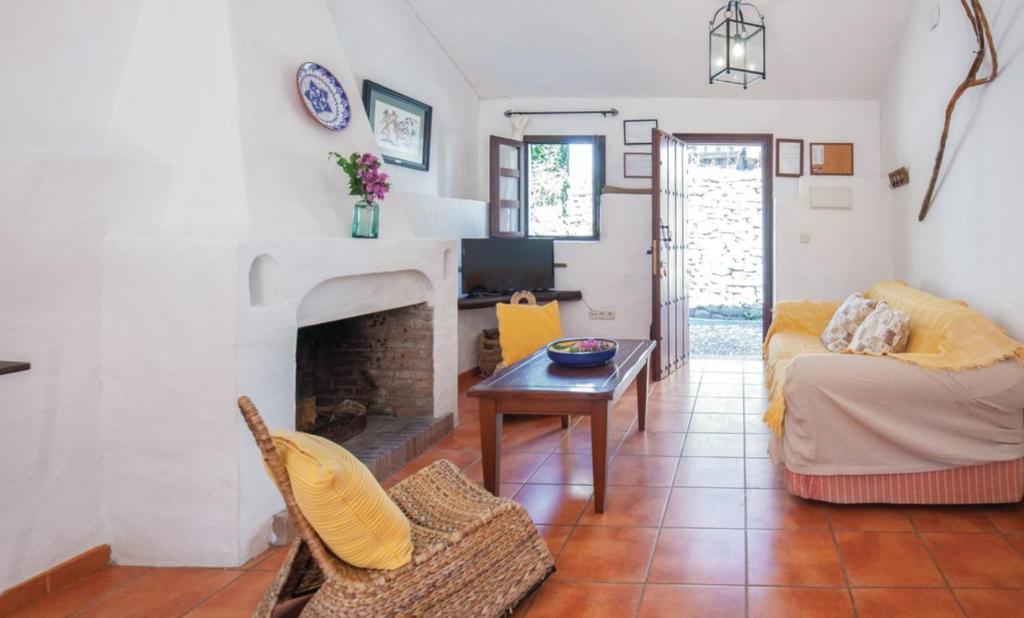 a living room with a couch and a fireplace at Finca El Huertezuelo in El Bosque