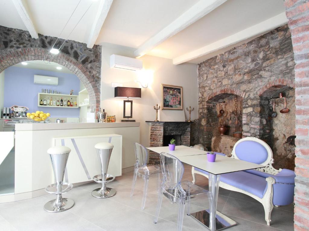 a kitchen with a table, chairs, and a fireplace at Hotel Souvenir in Monterosso al Mare