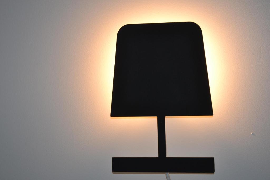 a black lamp sitting on top of a table at Vue d'en Haut in Durbuy