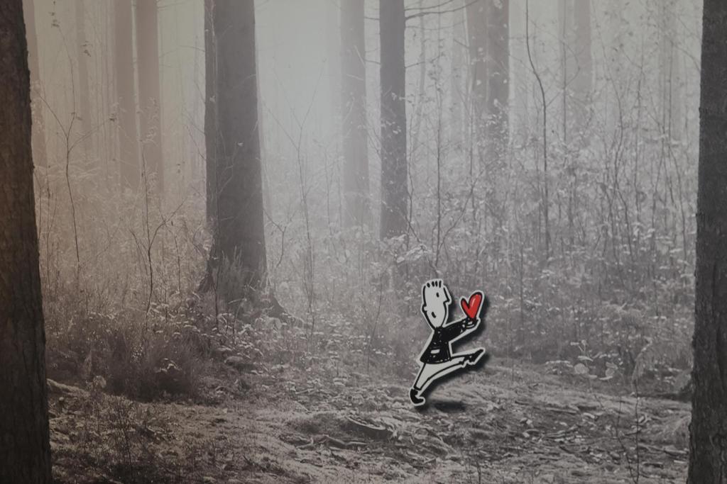 a cat figurine sitting in the middle of a forest at Vue d'en Haut in Durbuy