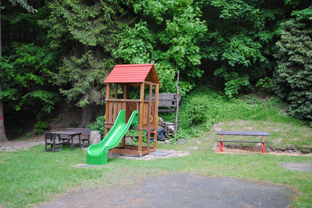 drewniany plac zabaw ze zjeżdżalnią i ławką w obiekcie Hotel pod Šikmou Věží w Jiczynie