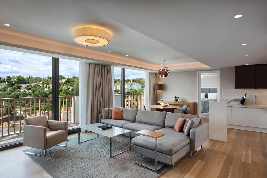 a living room with a couch and a table at The Grand Tarabya Managed by Accor in Istanbul