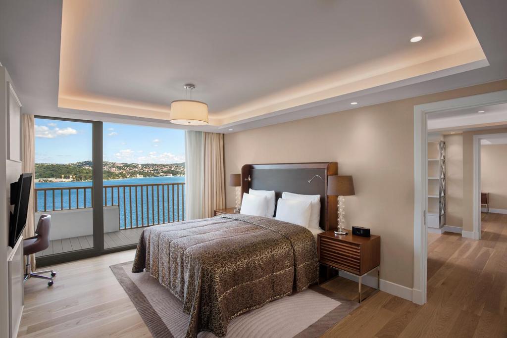 a hotel room with a bed and a balcony at The Grand Tarabya Managed by Accor in Istanbul