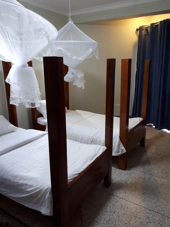 Postel nebo postele na pokoji v ubytování Njara Suites
