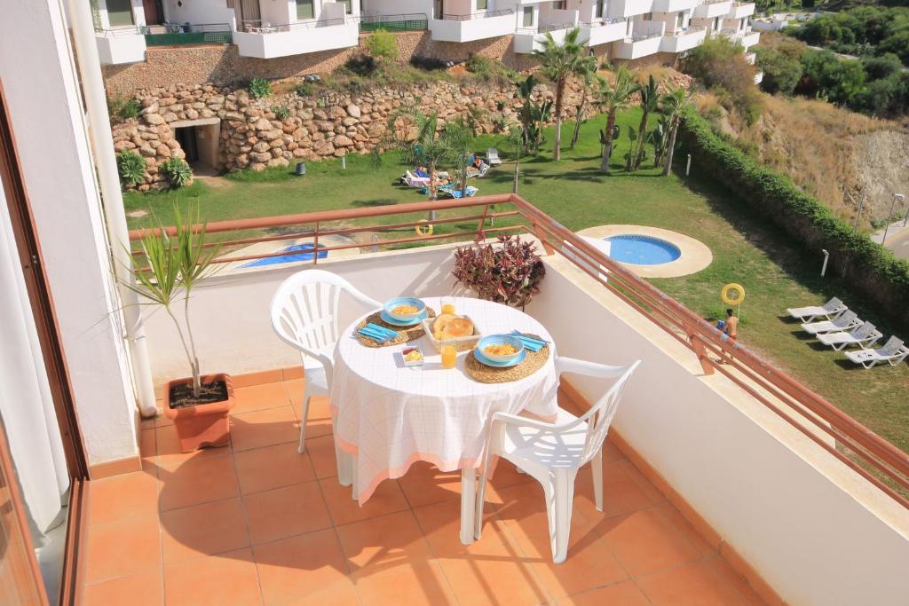 a table and chairs on a balcony with a view at Panorama de Nerja in Nerja