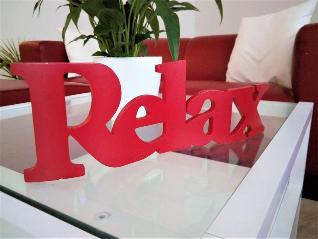 a red sign on a glass table with a potted plant at Ferienwohnung "Alte Druckerei" in Eisenberg