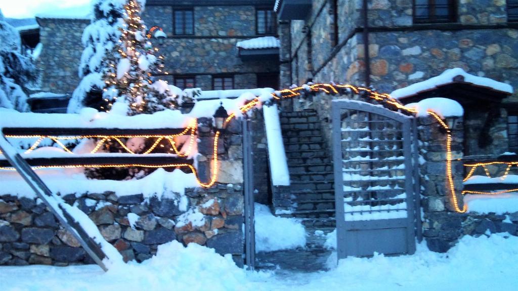 a slide covered in snow with a christmas tree at Luxurious Residence at the Village Square in Palaios Agios Athanasios