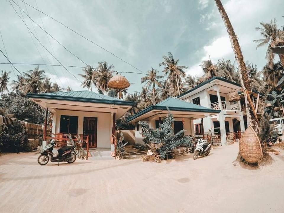 a house with a motorcycle parked in front of it at RGL Place Siargao in General Luna